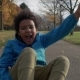 Cute Little Boy with Afro Hair Rides Sitting on Skateboard and Having Fun - VideoHive Item for Sale