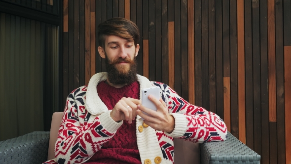Bearded Man Uses a Phone alt