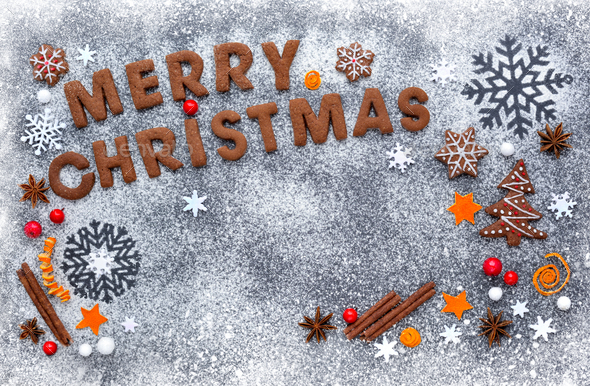 Merry Christmas cookies on a snowy flour with a dark background, - Stock Photo - Images