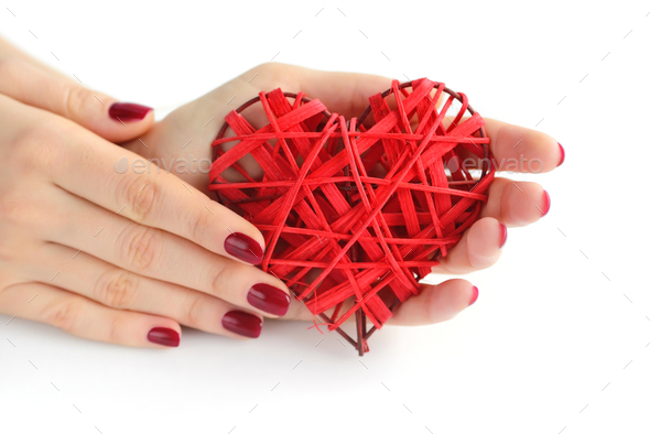 Wicker red heart in woman's hands on white background. Closeup h - Stock Photo - Images