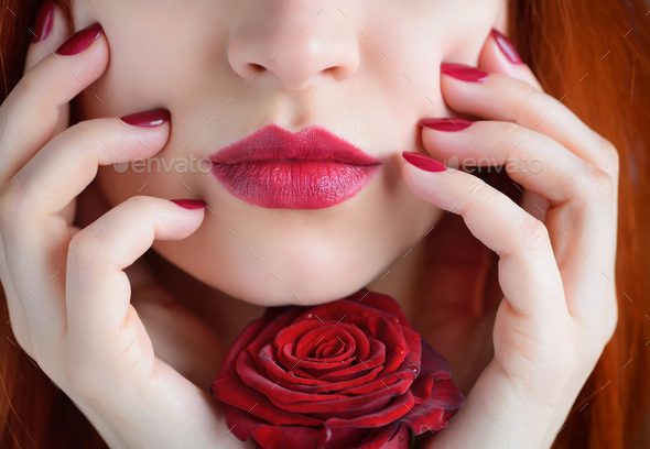 Portrait with red rose flower. Dark red lips and nails. Beautifu