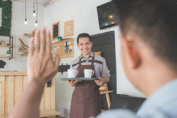 male waiter delivering coffee to his customer Stock Photo by odua | PhotoDune