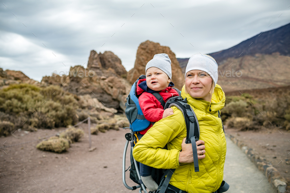 Super Mom with baby boy hiking in backpack - Stock Photo - Images