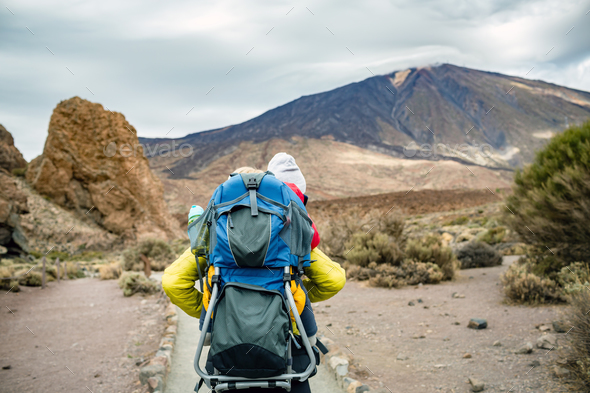 Super Mom with baby boy hiking in backpack - Stock Photo - Images