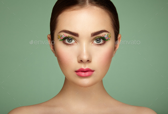 Young beautiful woman with flower makeup eyes - Stock Photo - Images