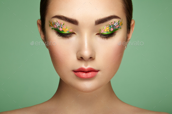 Young beautiful woman with flower makeup eyes - Stock Photo - Images