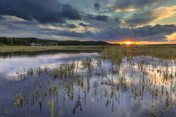 Dark river foreland landscape image with setting sun - Stock Photo - Images