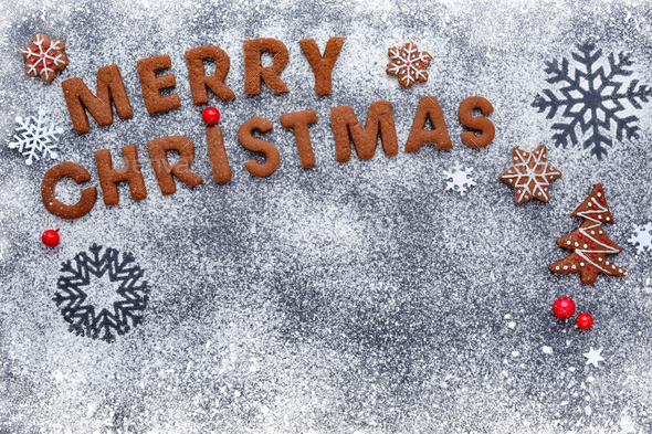 Merry Christmas cookies on a snowy flour with a dark background, - Stock Photo - Images