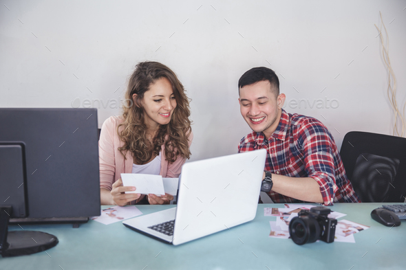 two photographers looking and pointing at their photo result af Stock Photo by odua