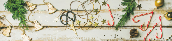 Holiday decoration toys, candles, rope, garlands, tree branches. Wide composition - Stock Photo - Images