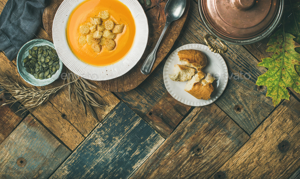 Fall pumpkin cream soup with croutons and seeds, flat-lay - Stock Photo - Images