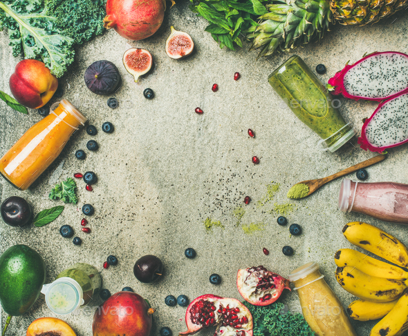Colorful smoothies in bottles with fresh fruits and greens - Stock Photo - Images