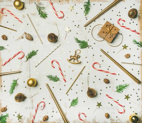 Flat-lay pattern of holiday decoration objects, toys, candles, white background - Stock Photo - Images