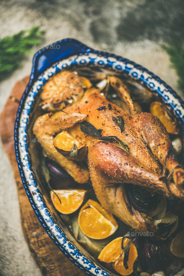 Roasted whole chicken with orange for Christmas eve celebration table - Stock Photo - Images