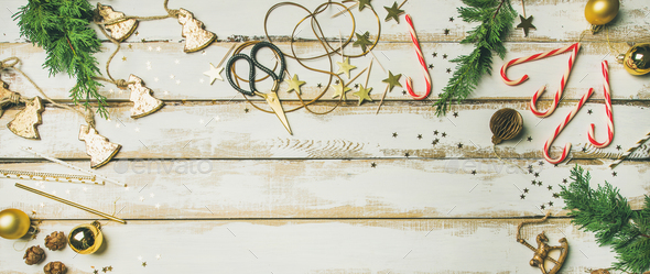 Holiday decoration toys, candles, rope, garlands, tree branches, candy cane - Stock Photo - Images