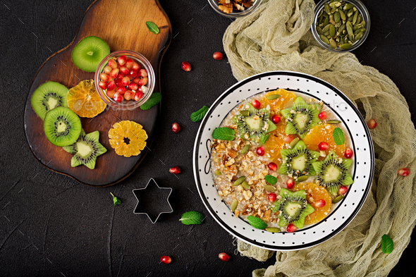 Tasty and healthy oatmeal porridge with fruit, berry and nuts. - Stock Photo - Images