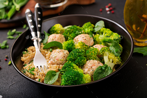 Baked meatballs of chicken fillet with garnish with quinoa and boiled broccoli - Stock Photo - Images