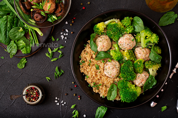 Baked meatballs of chicken fillet with garnish with quinoa and boiled broccoli - Stock Photo - Images