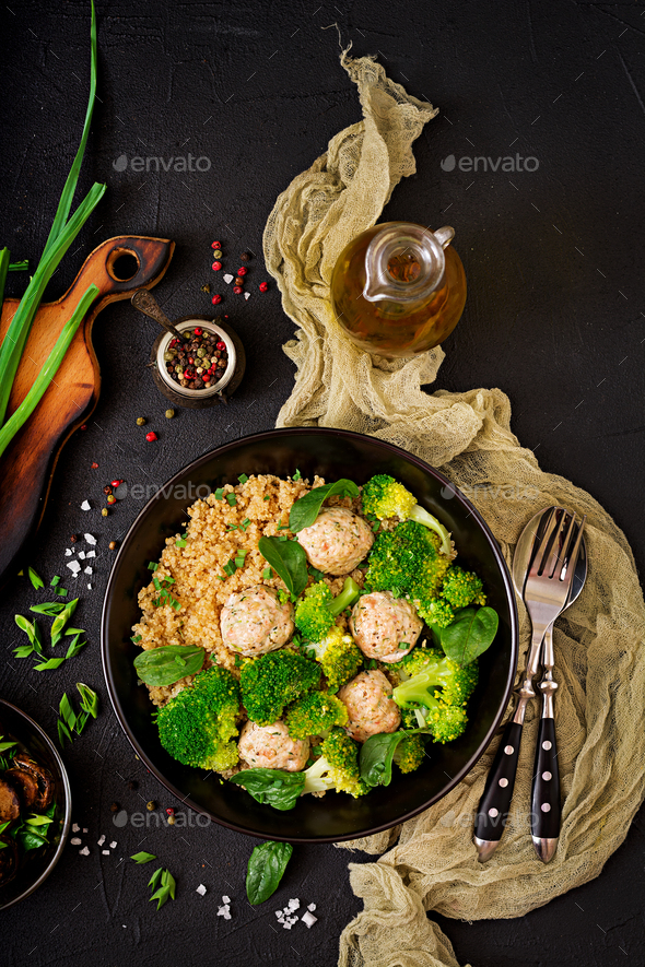 Baked meatballs of chicken fillet with garnish with quinoa and boiled broccoli - Stock Photo - Images
