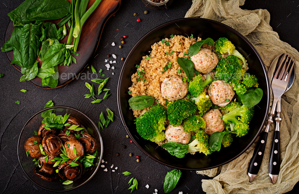Baked meatballs of chicken fillet with garnish with quinoa and boiled broccoli - Stock Photo - Images