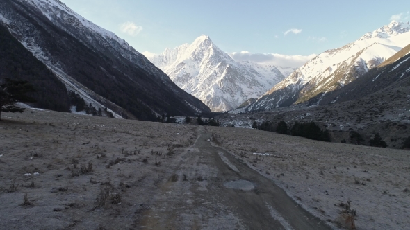 Frozen Mountain Road Leading To a Big White Mountain
