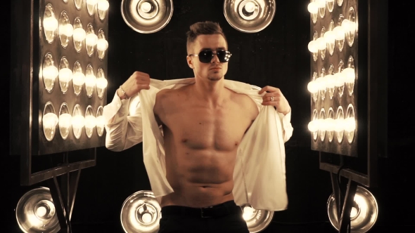 Sexy Man Dancing on the Background of Lights alt