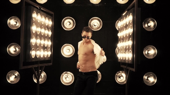 Sexy Man Dancing on the Background of Lights alt