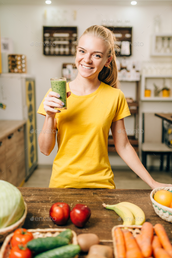 Woman with cocktail of fresh fruit and vegetables - Stock Photo - Images