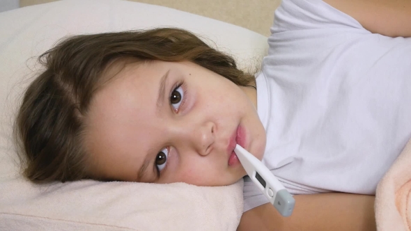 Sick Child Portrait with Thermometer in Bed