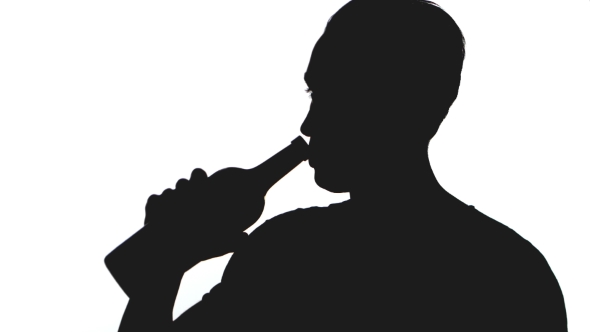 Silhouette of Young Man Drinks Alcohol From a Bottle Isolated on White Background alt