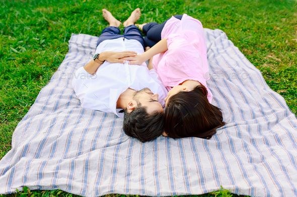 Young loving couple lying together enjoying closeness - Stock Photo - Images