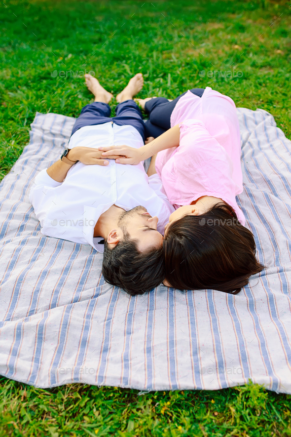 Young loving couple lying together enjoying closeness - Stock Photo - Images