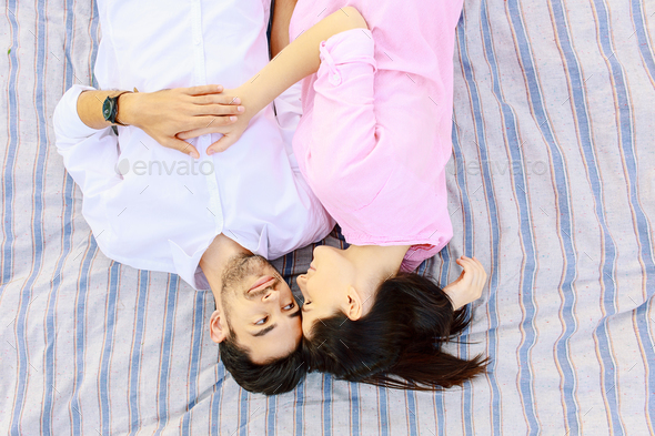 Happy young man and woman looking in love to each other - Stock Photo - Images