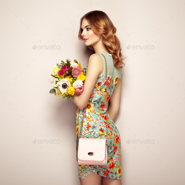 Blonde young woman in elegant floral dress - Stock Photo - Images