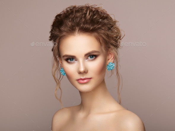 Fashion portrait of young beautiful woman with elegant hairstyle