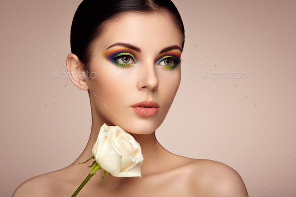 Portrait of beautiful young woman with rainbow make-up - Stock Photo - Images
