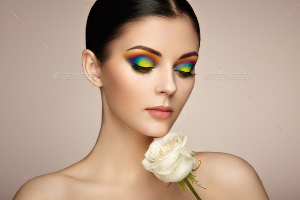 Portrait of beautiful young woman with rainbow make-up - Stock Photo - Images