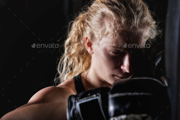 Young Women Hitting Boxing Bag Stock Photo by microgen | PhotoDune