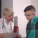 The Kind Woman Medic is Giving List with Medicaments to Young Patient - VideoHive Item for Sale