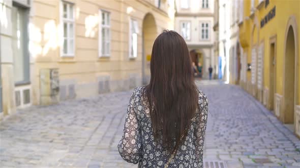 Woman Walking in City. Young Attractive Tourist Outdoors in Italian City alt