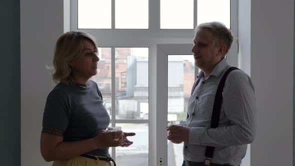 Male with Mature Mom Talking By a Window at Home alt
