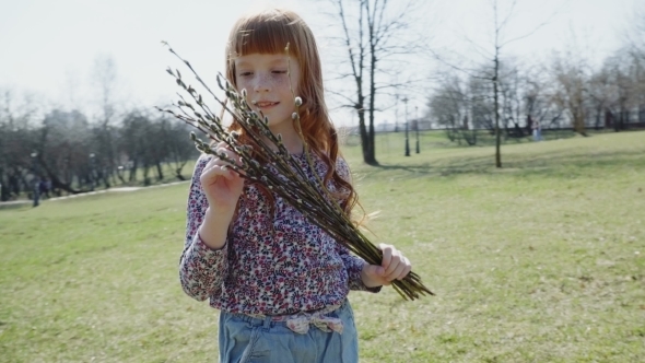Cute Ginger Girl with a Spring Bunch of Branches