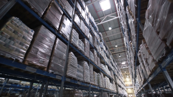 Shelves of Cardboard Boxes Inside a Storage Warehouse alt