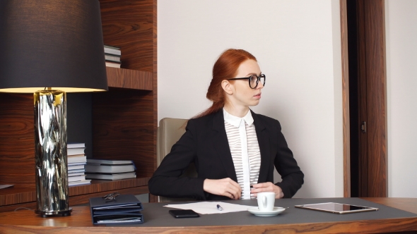 Young Businesswoman Using Tablet Computer in Hotel Room.