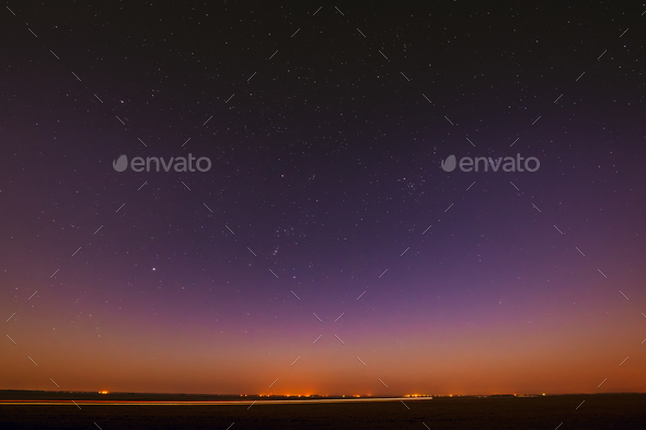 Night Starry Sky Over Yellow Sunset Or Sunrise Lights. Night Glo - Stock Photo - Images