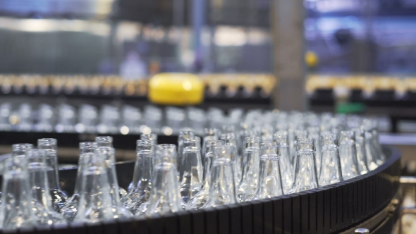 Spill in Glass Bottles at the Plant Conveyor alt