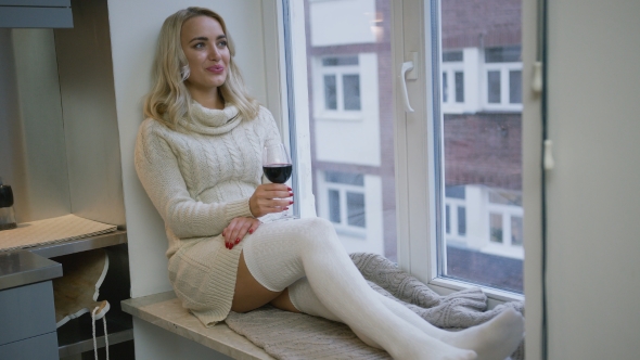 Woman Drinking Wine Near Window alt