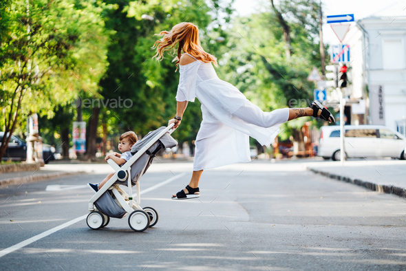 mom with a stroller crosses the road