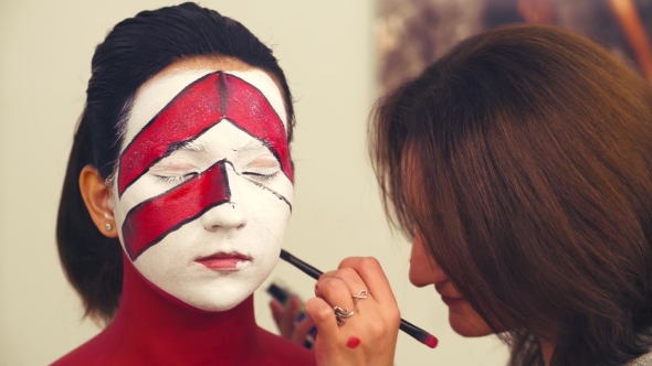 Makeup Artist Drawing Outline on the Model's Face