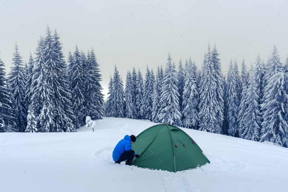 Green tent in winter mountains - Stock Photo - Images